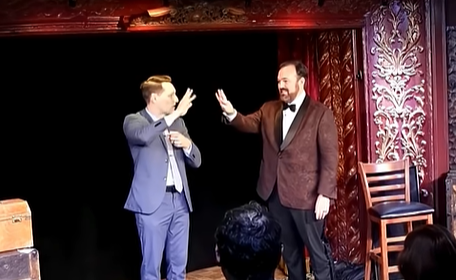 Matt Donnelly and partner onstage wiggling fingers at one another