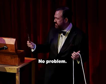 Matt Donnelly in his magic show displaying his "magic wand" which is actually a bowie knife