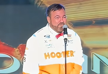 Matt Donnelly in a Hooters jacket with his hands handcuffed out of frame