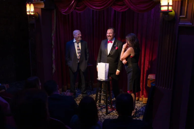 Matt Donnelly the Mind Noodler on stage in The Parlour at The Magic Castle with a married couple from the audience